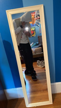 a person is standing in front of a mirror