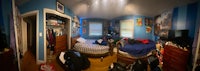 a fish eye view of a bedroom with a bed and a desk
